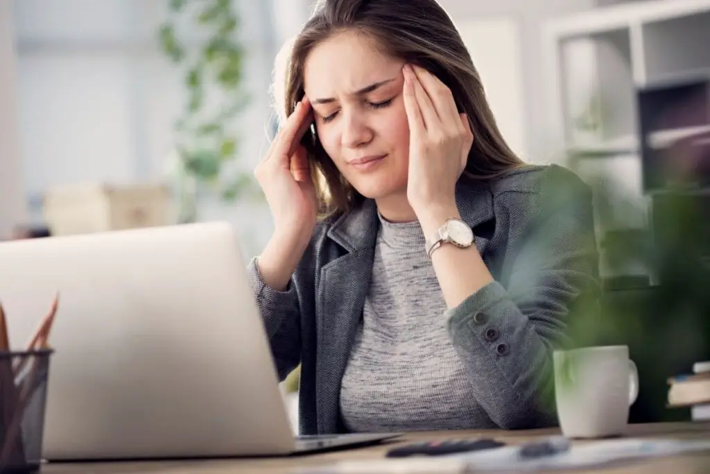 women at computer with headache