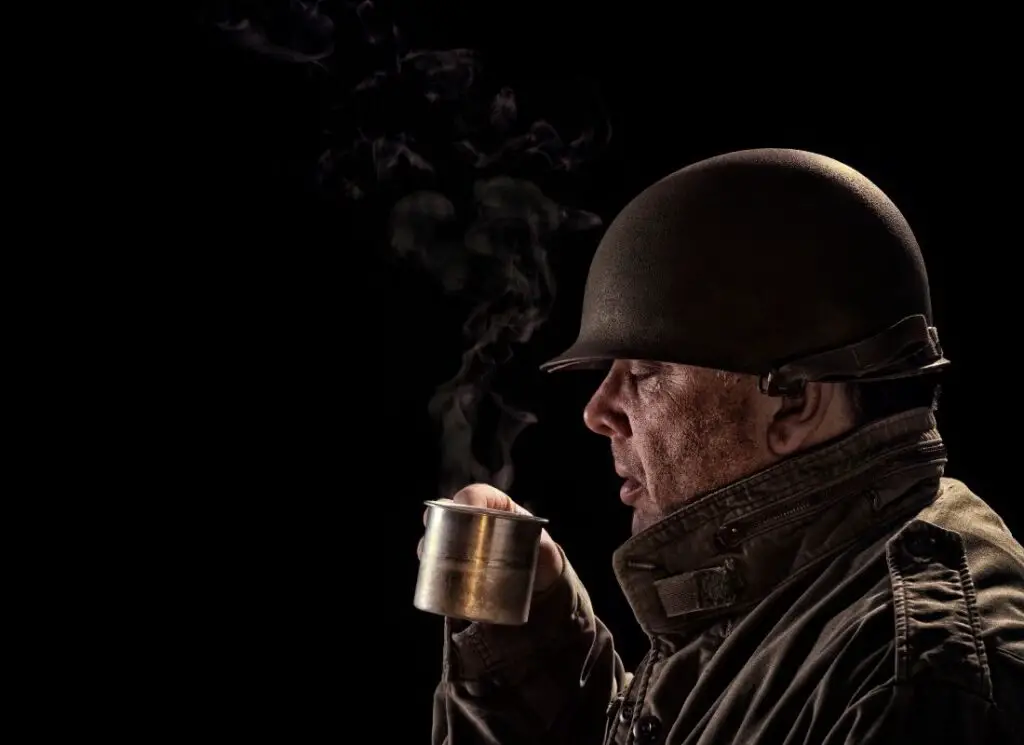 vintage soldier drinking coffee in an aluminum cup